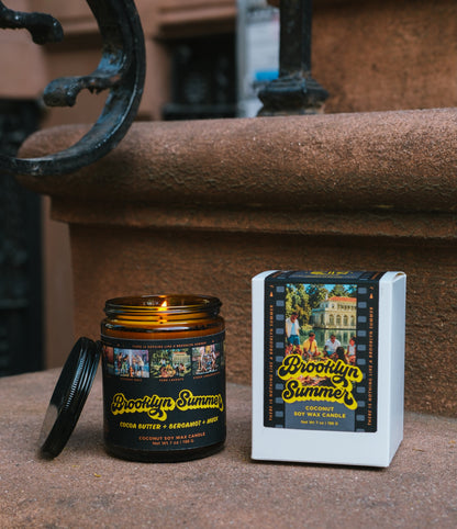 Candle and packaging of Brooklyn Summer on a stone surface